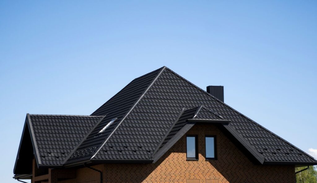black metal roof tiles and light brown brick wall