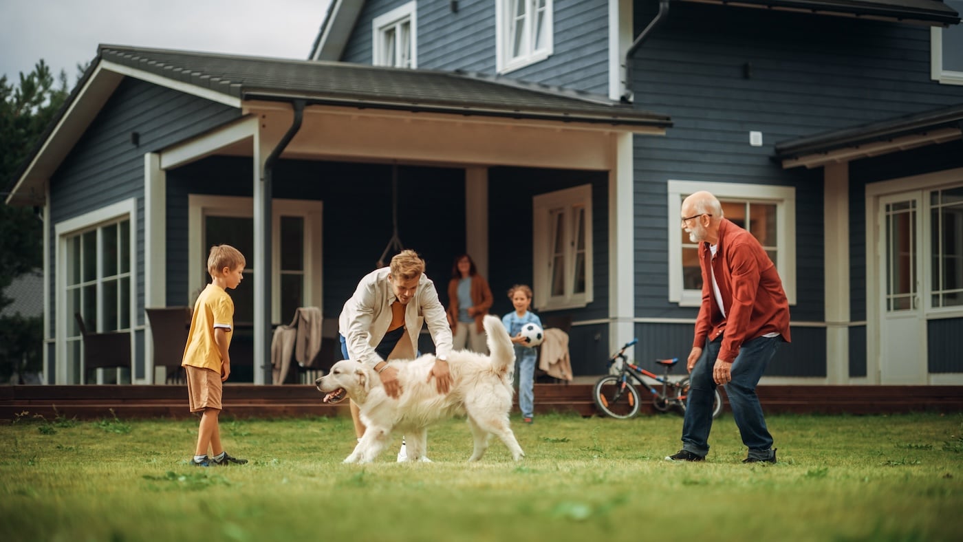 family playing in front of home